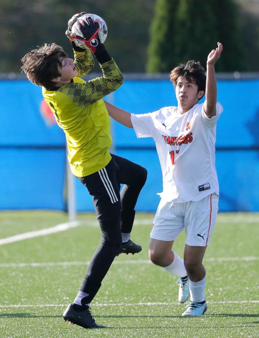 Union Grove High School's Finn Jacobs (1) pulls down a cross as West De Pere High School's Richard Perez (17) pursues during their WIAA Division 2 boys soccer championship game Saturday, November 4, 2023, at Uihlein Soccer Park in Milwaukee, Wis.