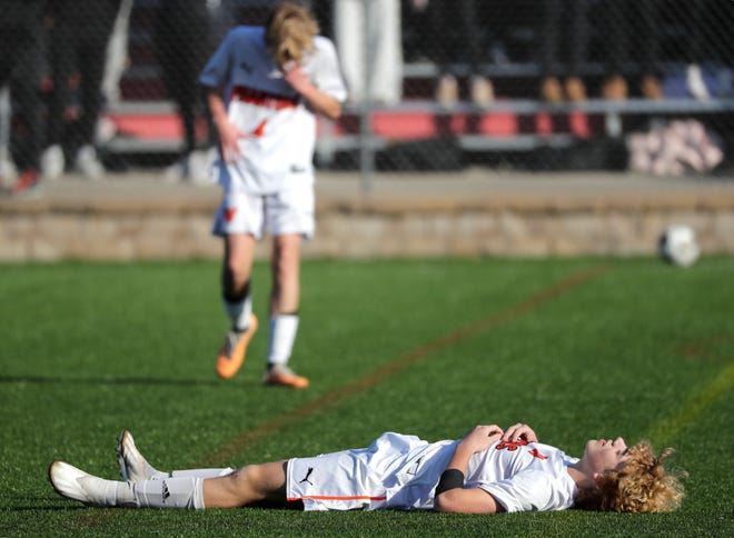 West De Pere High School's Landen Arnstad, bottom, and teammate Grayson Birder, back, react moments after time expires in a 1-0 loss to Union Grove High School during their WIAA Division 2 boys soccer championship game Saturday, November 4, 2023, at Uihlein Soccer Park in Milwaukee, Wis.